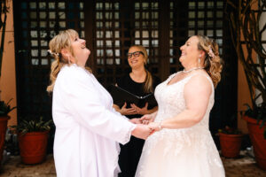 Same sex wedding ceremony at Disney Swan courtyard in Orlando Florida officiated by Karen Hooper